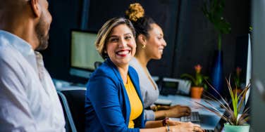 woman working on computer and smiling 