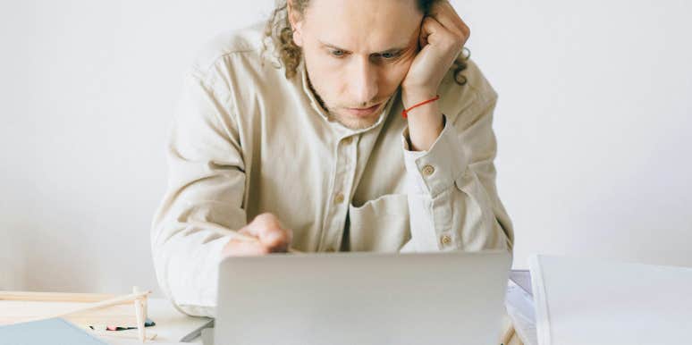 frustrated man looking at laptop