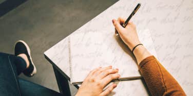Woman writing a letter to her abuser