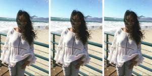 woman on beach with hair blowing in the wind