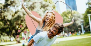 happy couple being playful in the park on a sunny day